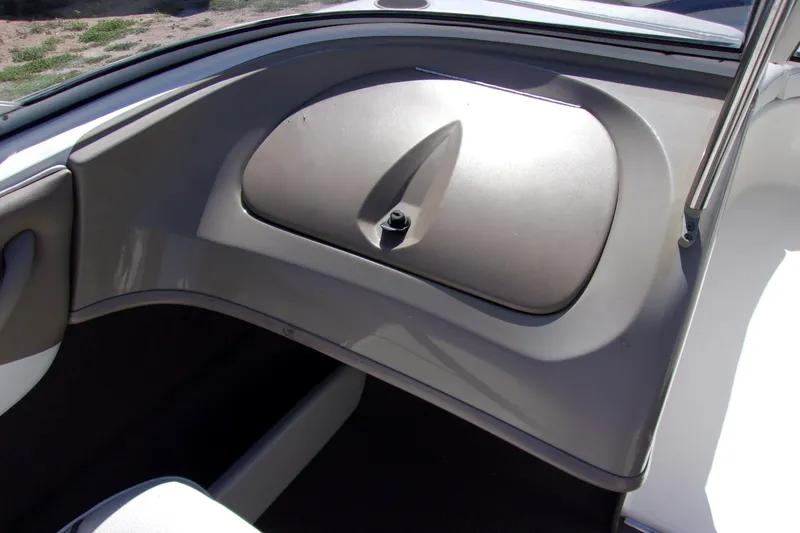 Slide: The Image of Interior view of a 2003 Bayliner 205 boat dashboard with glove compartment. - 5