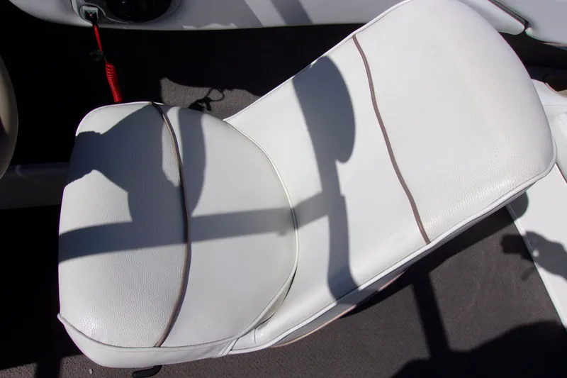 Slide: The Image of White seat on a 2003 Bayliner 205 boat, featuring clean upholstery and shadow details. - 6