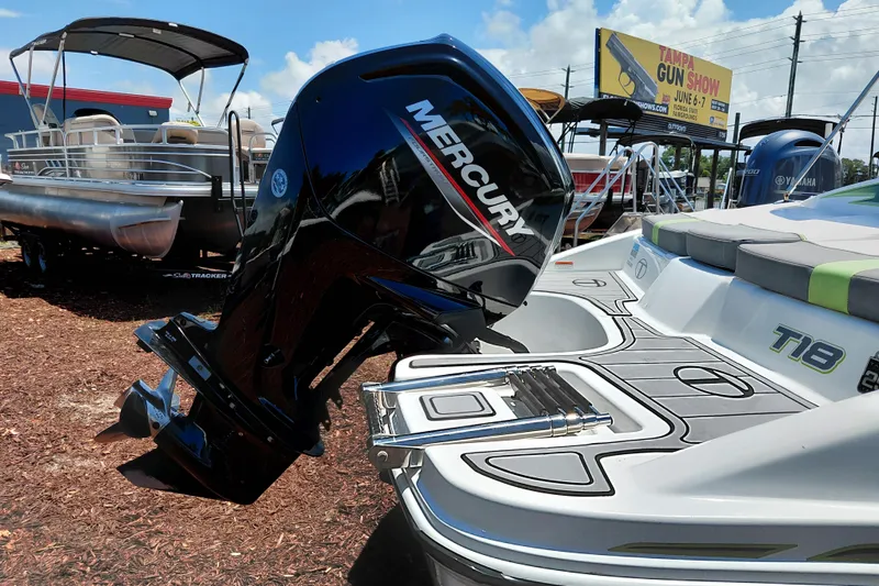 Slide: The Image of 2023 Tahoe T18 boat with Mercury outboard motor displayed outdoors. - 11