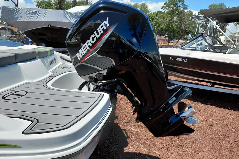 Slide: The Image of 2023 Tahoe T18 boat with Mercury outboard motor, docked outdoors. - 12