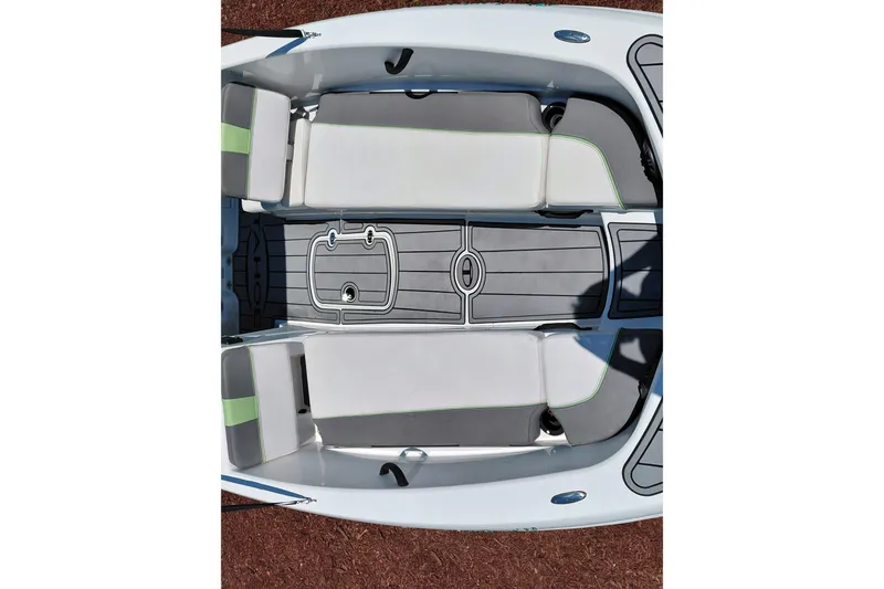 Slide: The Image of 2023 Tahoe T18 boat interior with gray and white seating, overhead view. - 13