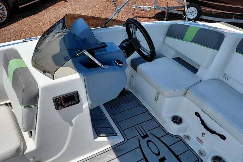 Slide: The Image of 2023 Tahoe T18 boat interior with steering wheel and seating area. - 25
