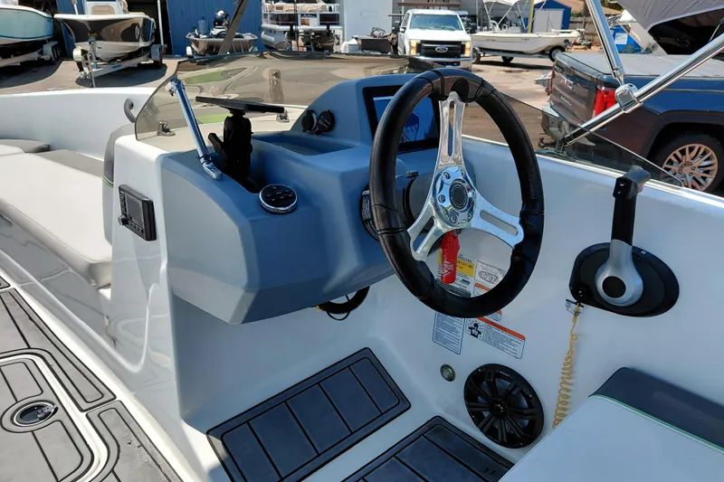 Slide: The Image of 2023 Tahoe T18 boat cockpit with steering wheel and control panel. - 27