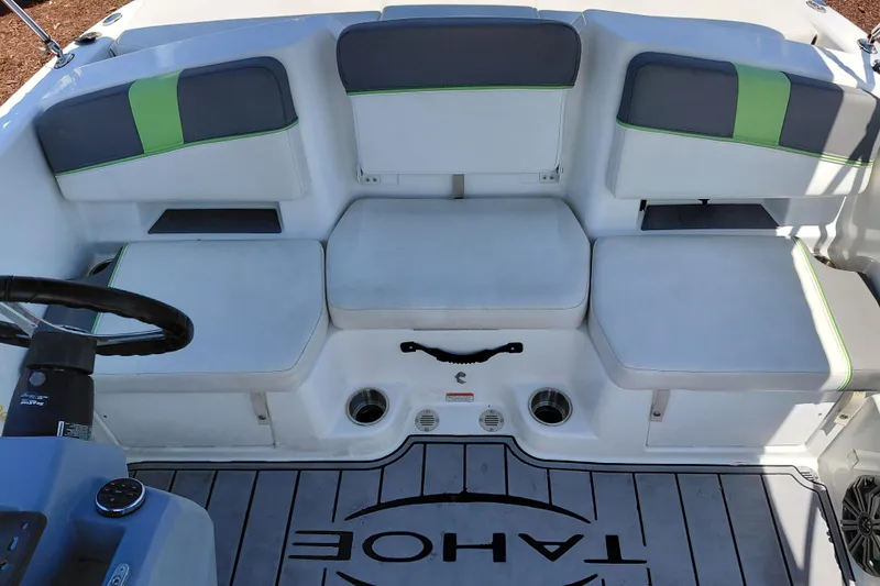 Slide: The Image of 2023 Tahoe T18 boat interior with cushioned seating and steering wheel. - 32