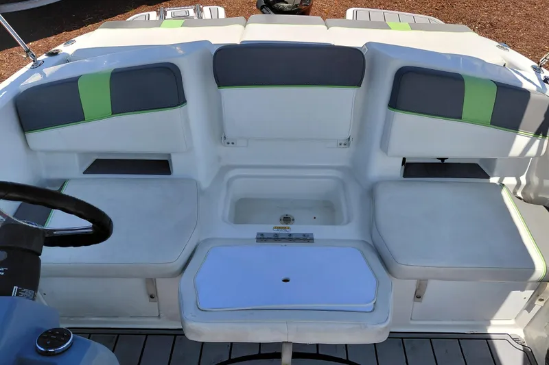 Slide: The Image of 2023 Tahoe T18 boat interior with gray and green seating, featuring a central storage compartment. - 35