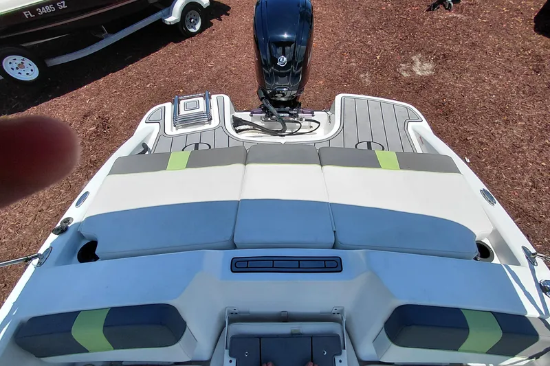 Slide: The Image of 2023 Tahoe T18 boat with cushioned seating and outboard motor, viewed from above. - 36