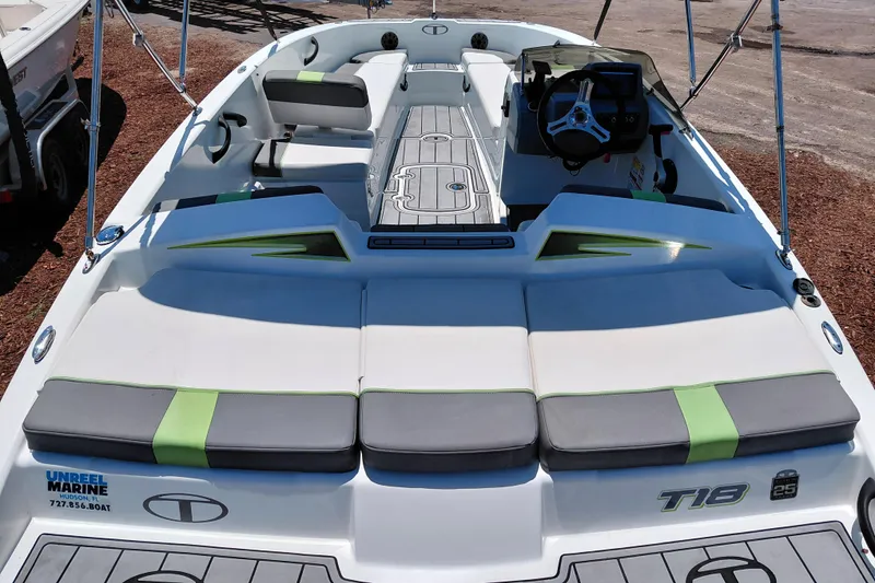 Slide: The Image of 2023 Tahoe T18 boat interior with modern seating and steering wheel. - 37