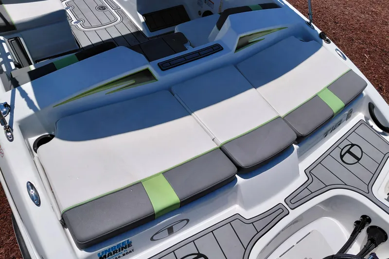 Slide: The Image of 2023 Tahoe T18 boat interior with gray and green cushioned seating. - 38