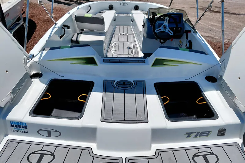 Slide: The Image of 2023 Tahoe T18 boat interior with seating, steering wheel, and storage compartments. - 41