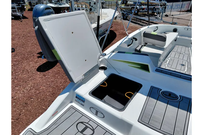 Slide: The Image of 2023 Tahoe T18 boat interior with open storage compartment and seating area. - 43