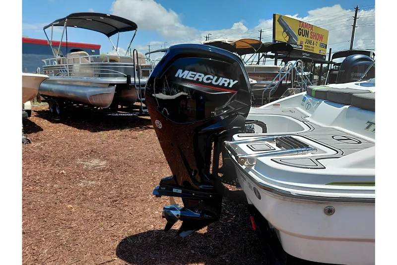 Slide: The Image of 2023 Tahoe T18 boat with Mercury outboard motor displayed outdoors. - 48