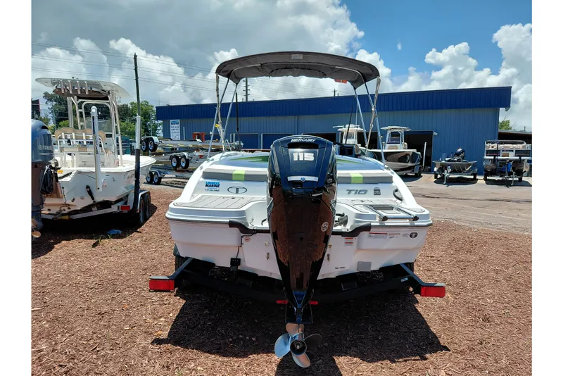 Slide: The Image of 2023 Tahoe T18 boat with Mercury 115 engine, displayed outdoors under a cloudy sky. - 49