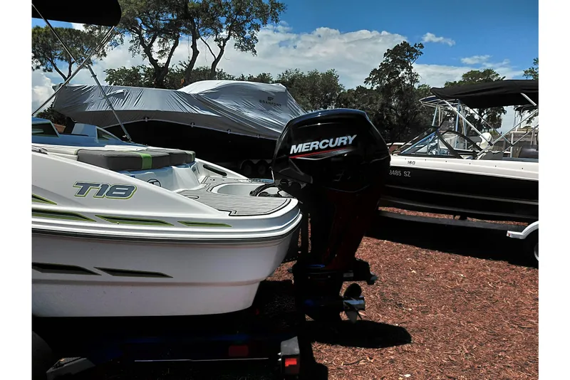 Slide: The Image of 2023 Tahoe T18 boat with Mercury engine in a marina setting. - 51