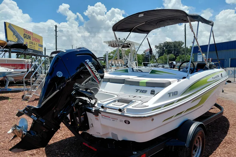 Slide: The Image of 2023 Tahoe T18 boat with Mercury engine on display outdoors. - 8