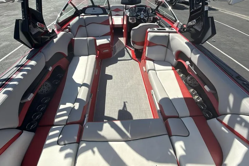 Slide: The Image of 2016 Supra SE 550 boat interior with red and white seating, modern dashboard, and spacious layout. - 10