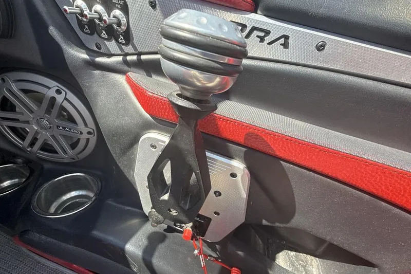 Slide: The Image of Interior of a 2016 Supra SE 550 boat featuring controls and JL Audio speaker. - 16