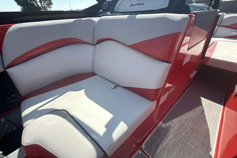 Slide: The Image of 2016 Supra SE 550 boat interior with red and white seating, showcasing luxury design. - 17