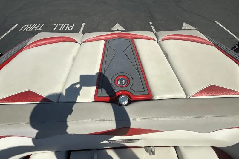 Slide: The Image of 2016 Supra SE 550 boat interior with red and white upholstery, shadow visible. - 19