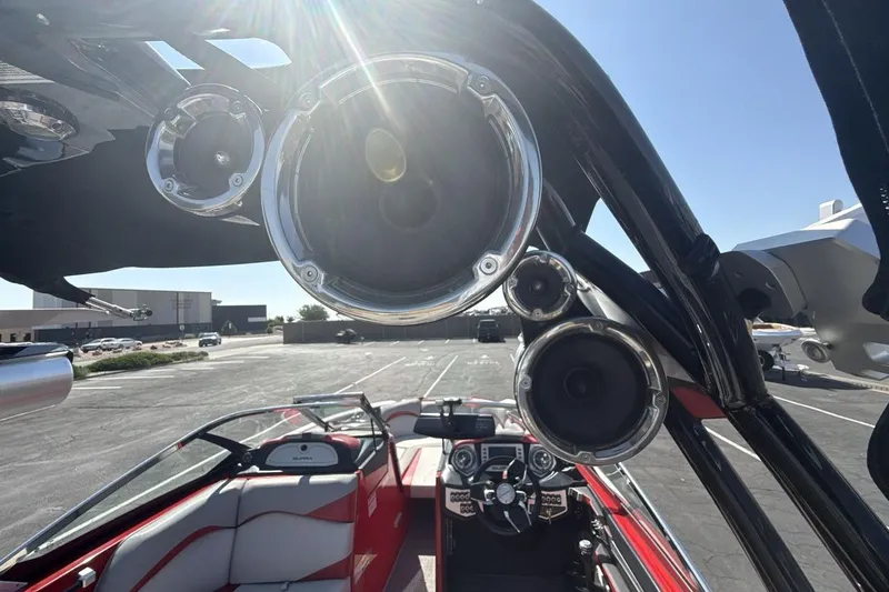 Slide: The Image of 2016 Supra SE 550 boat interior with speakers and steering wheel in a parking lot. - 21