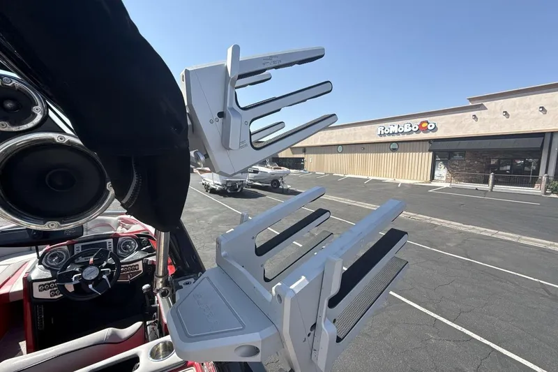 Slide: The Image of 2016 Supra SE 550 boat with speakers and wakeboard racks in parking lot. - 22