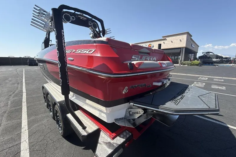 Slide: The Image of 2016 Supra SE 550 boat in parking lot, showcasing sleek red design and advanced features. - 3
