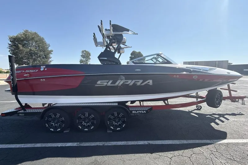 Slide: The Image of 2016 Supra SE 550 boat on trailer, featuring sleek design and vibrant red accents. - 6