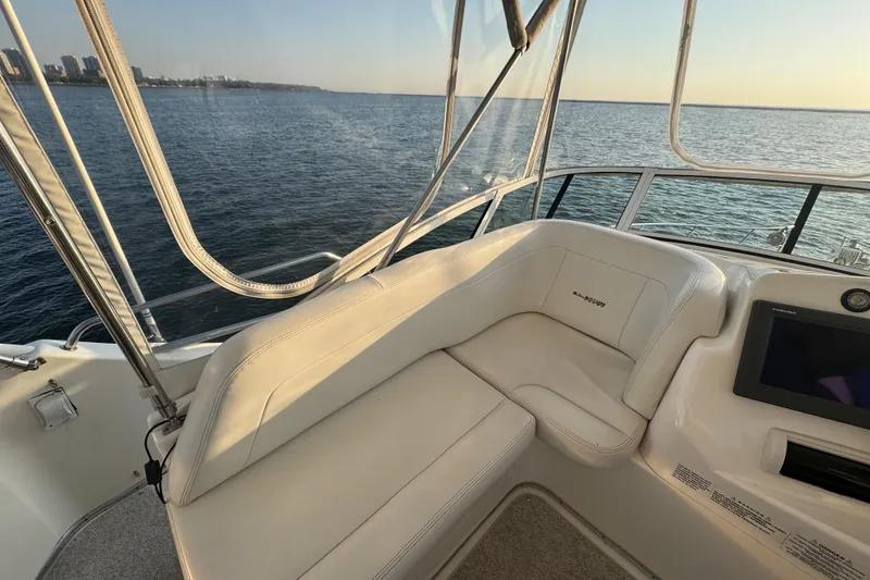 Slide: The Image of 2003 Silverton 410 Sport Bridge interior with ocean view at sunset. - 31