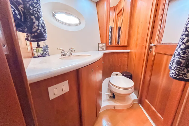 Slide: The Image of Bathroom interior of 2003 Silverton 410 Sport Bridge yacht with wooden cabinetry. - 76