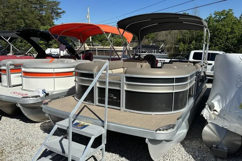 The Image of 2019 Bennington SX 22 SLXP pontoon boat with canopy, parked on gravel lot. - 1