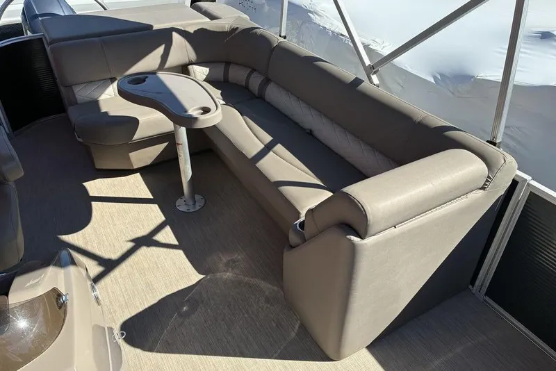 Slide: The Image of 2019 Bennington SX 22 SLXP boat interior with beige seating and table. - 3