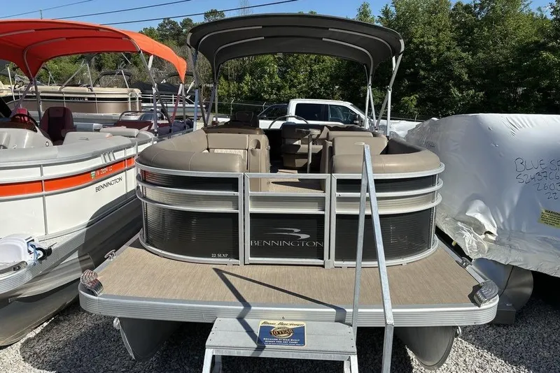 Slide: The Image of 2019 Bennington SX 22 SLXP pontoon boat with canopy, parked outdoors. - 4