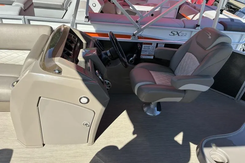 Slide: The Image of 2019 Bennington SX 22 SLXP boat interior with captain's chair and control panel. - 6