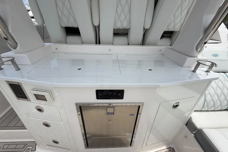 Slide: The Image of 2021 Regal 33 SAV boat interior with sleek white cabinetry and stainless steel fridge. - 10