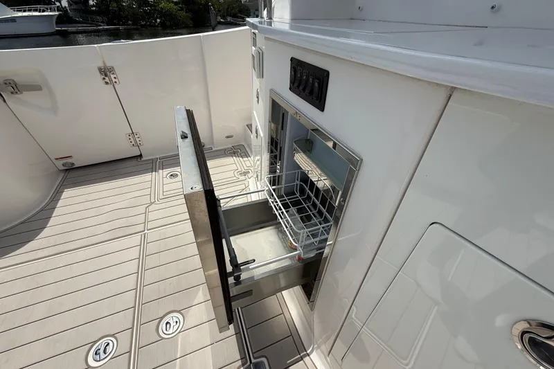 Slide: The Image of Open drawer on 2021 Regal 33 SAV boat deck, showcasing storage space. - 12