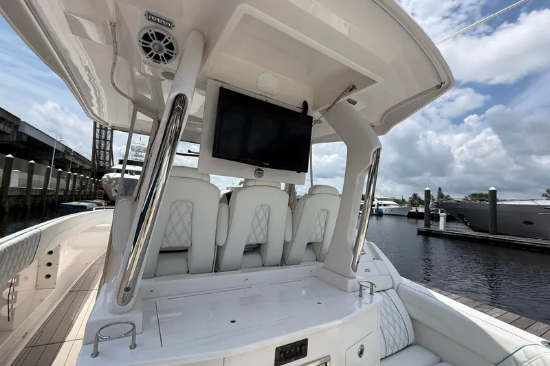 Slide: The Image of 2021 Regal 33 SAV boat interior with seating, TV, and marina view. - 13