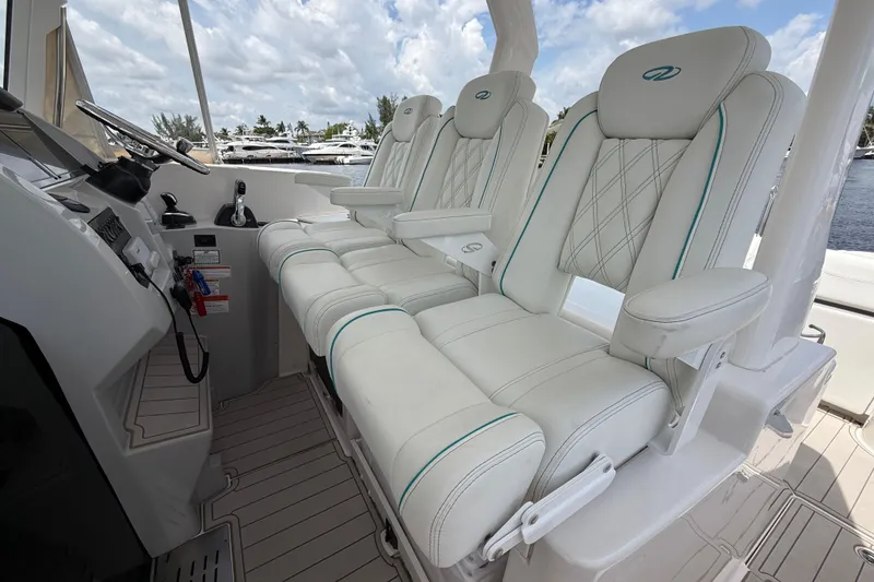 Slide: The Image of Luxurious seating on a 2021 Regal 33 SAV boat, featuring elegant white upholstery. - 15
