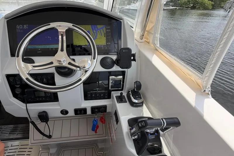 Slide: The Image of 2021 Regal 33 SAV boat helm with modern controls and navigation displays. - 16