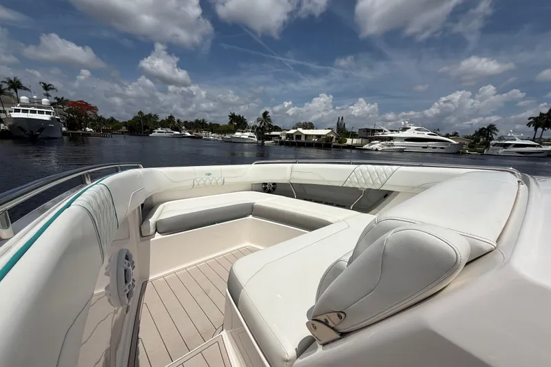 Slide: The Image of Luxurious 2021 Regal 33 SAV boat interior with plush seating, docked by a scenic waterfront. - 22