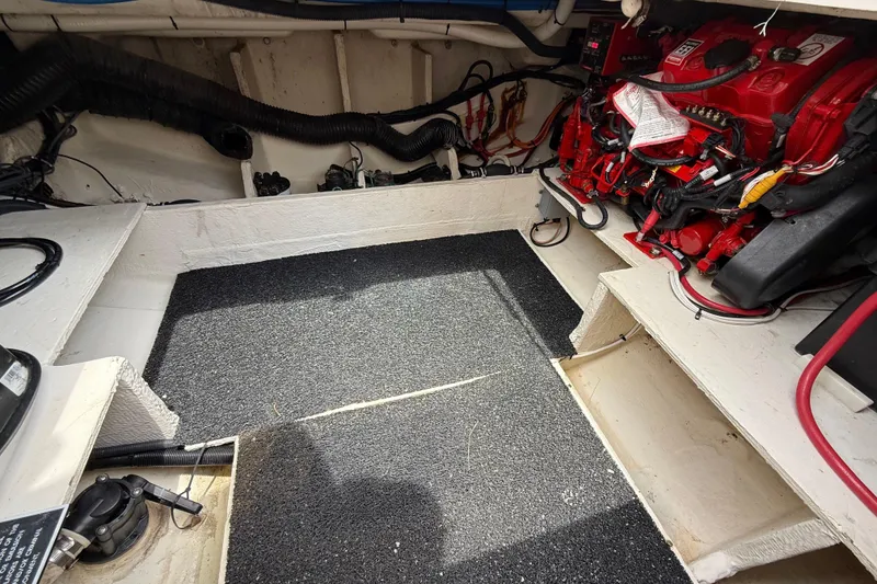 Slide: The Image of Engine compartment of a 2021 Regal 33 SAV boat, featuring red engine components. - 25