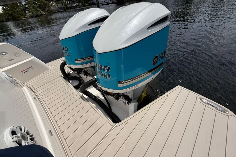 Slide: The Image of 2021 Regal 33 SAV boat with twin Yamaha outboard engines on water. - 5