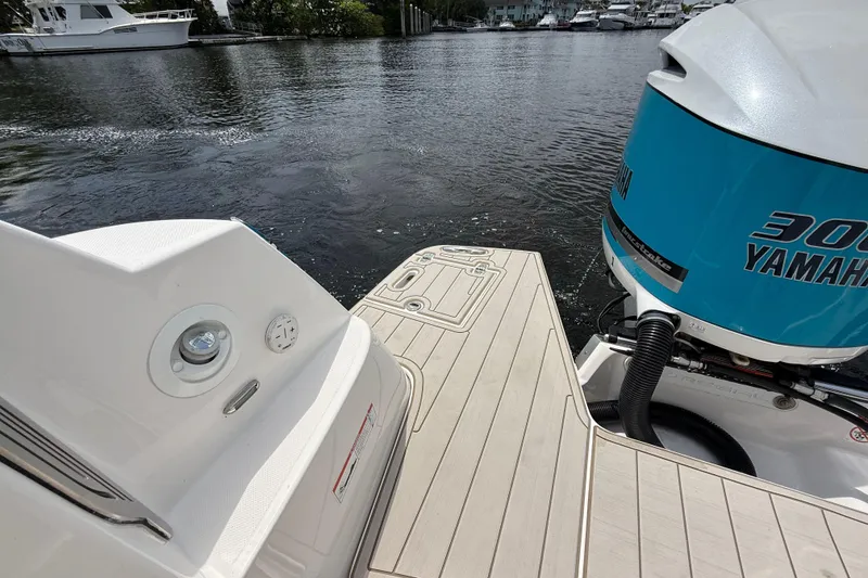 Slide: The Image of 2021 Regal 33 SAV boat with Yamaha 300 engine on a calm waterway. - 6