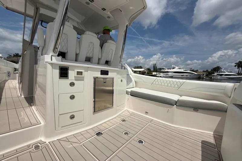 Slide: The Image of 2021 Regal 33 SAV boat interior with luxurious seating and modern amenities under a blue sky. - 7