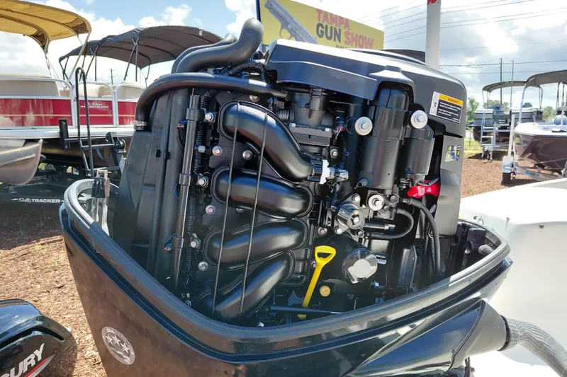 Slide: The Image of 2021 Bayliner 160 Bowrider outboard engine displayed at a boat show. - 12