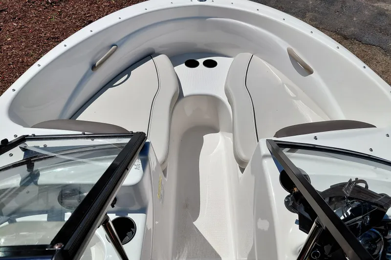 Slide: The Image of 2021 Bayliner 160 Bowrider interior with seating and windshield, showcasing sleek design. - 13