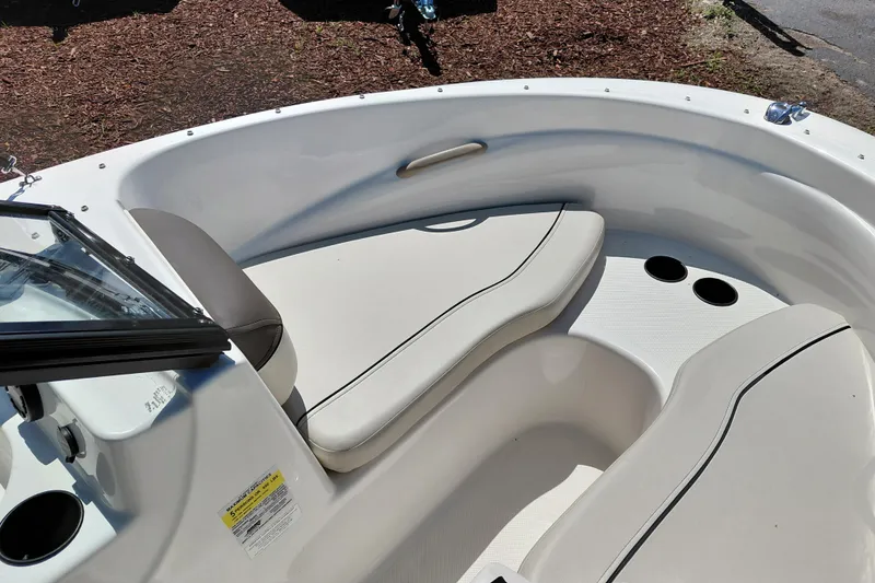 Slide: The Image of 2021 Bayliner 160 Bowrider interior with cushioned seating and cup holders. - 14