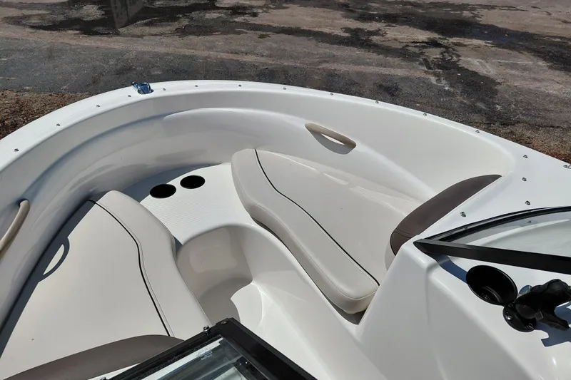 Slide: The Image of 2021 Bayliner 160 Bowrider boat interior with seating and cup holders. - 15