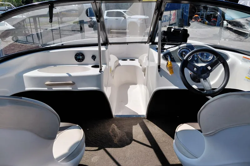 Slide: The Image of 2021 Bayliner 160 Bowrider interior with steering wheel, dashboard, and seating. - 16