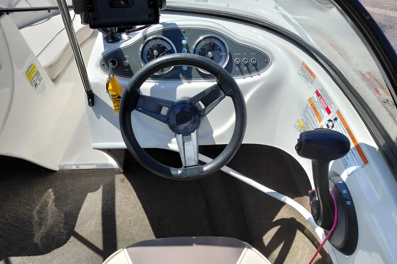 Slide: The Image of 2021 Bayliner 160 Bowrider dashboard with steering wheel and control panel. - 18