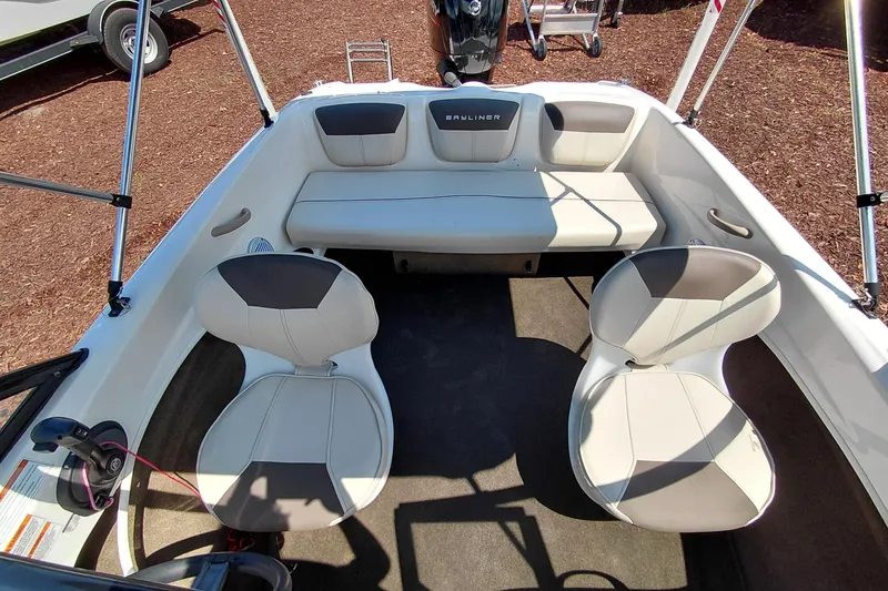 Slide: The Image of 2021 Bayliner 160 Bowrider interior with seating and steering wheel, showcasing modern design. - 21