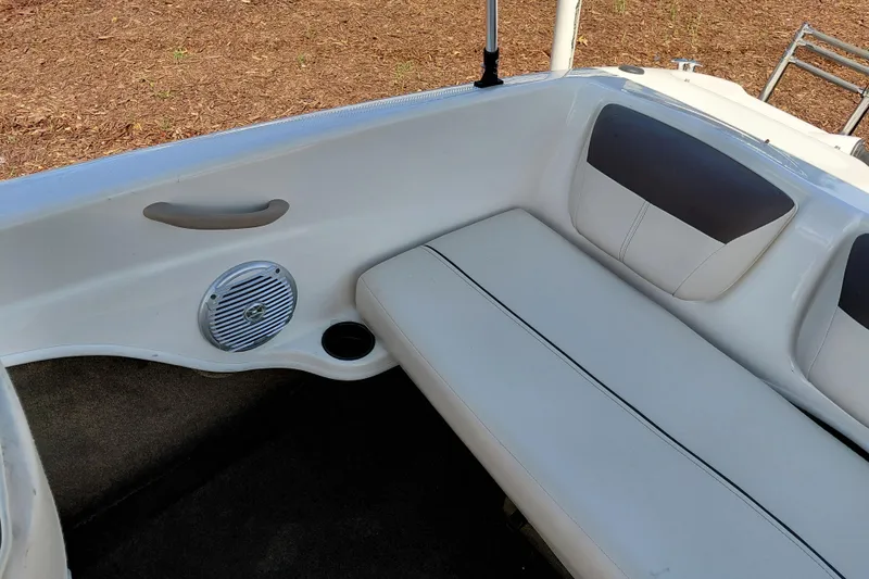 Slide: The Image of 2021 Bayliner 160 Bowrider interior with white seating and speaker detail. - 25